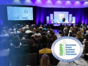 A speaker addresses a seated audience at a conference. A large screen displays a photo, and an International Society for Medical Publication Professionals (ISMPP) Silver Level Sponsor logo is visible in the foreground.