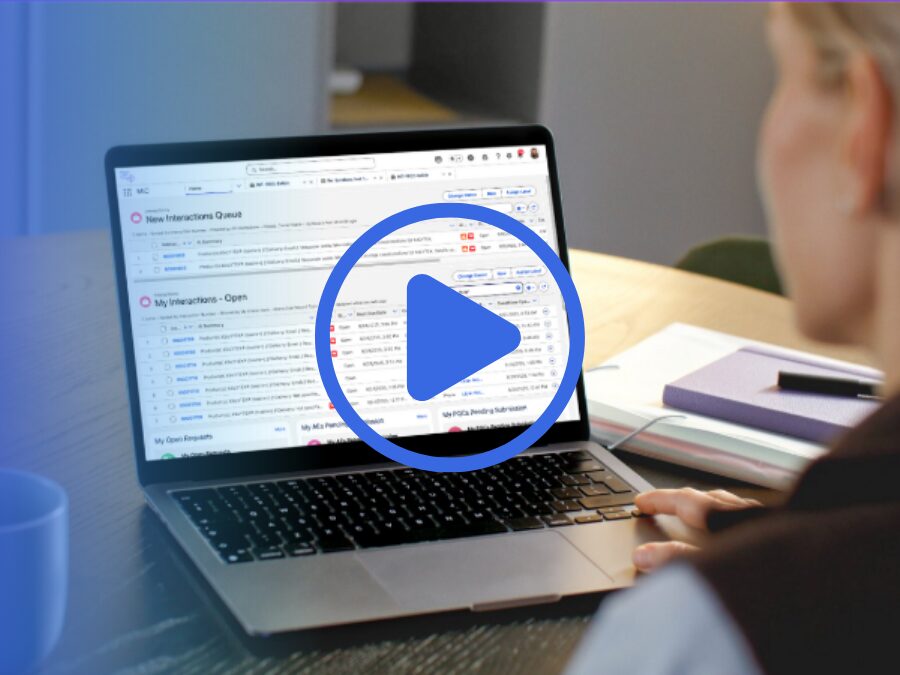 Person viewing a laptop screen displaying an email or messaging interface, with a large blue play button icon overlaid on the image.