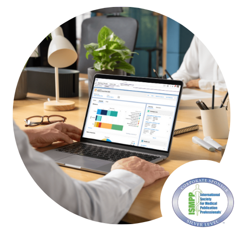 Image of a person's hands on a table with Scientific Publications software on a laptop in front of them.